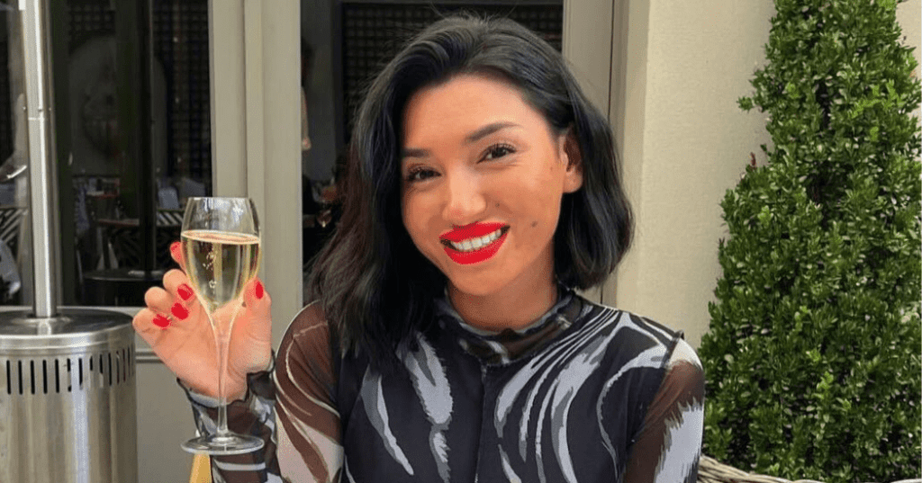 Pictured is Ella May Ding holding a glass