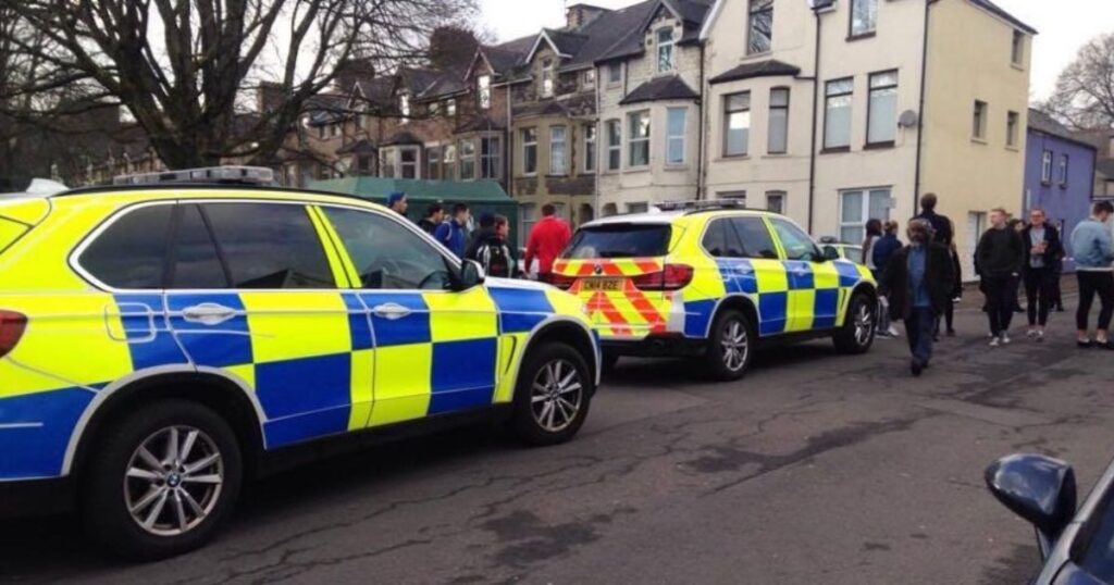 Two police cars parked in a street