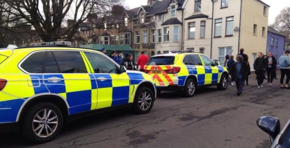 Two police cars parked in a street