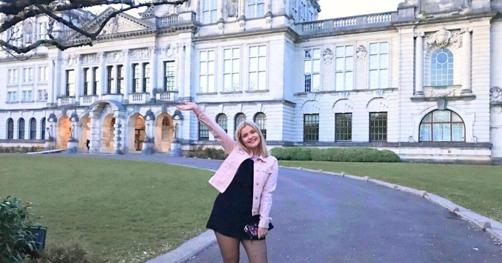 a uni student in front of the main building of cardiff university