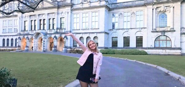 a uni student in front of the main building of cardiff university
