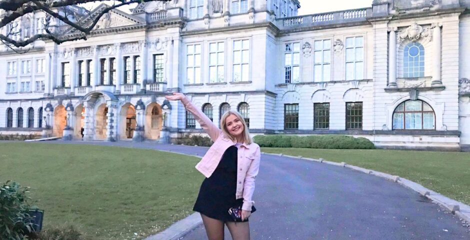 a uni student in front of the main building of cardiff university