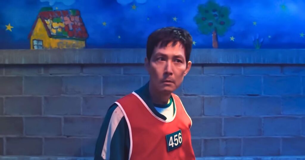 gi-hun in the creepy hide and seek challenge in netflix's squid game