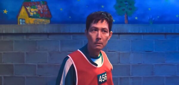 gi-hun in the creepy hide and seek challenge in netflix's squid game