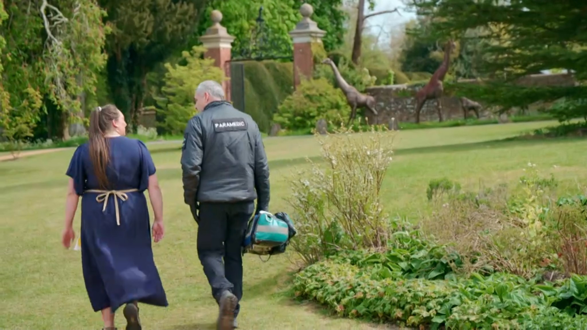 A paramedic escorting Shannon from the Bake Off tent