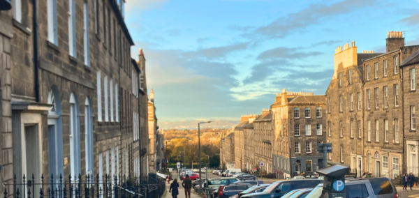 some houses in edinburgh and also some university students in the distance