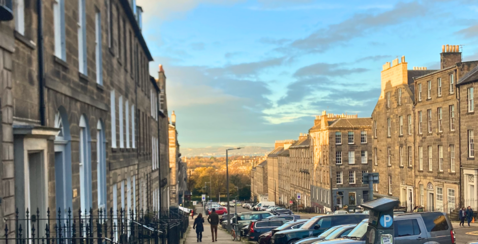 some houses in edinburgh and also some university students in the distance