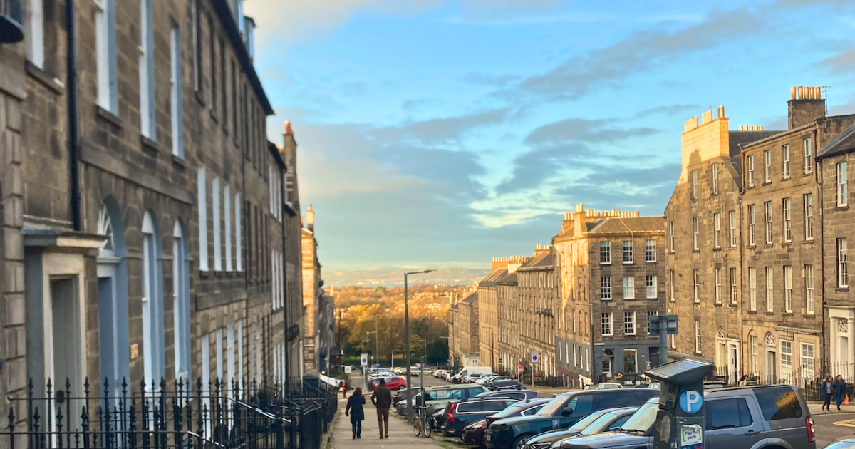 some houses in edinburgh and also some university students in the distance