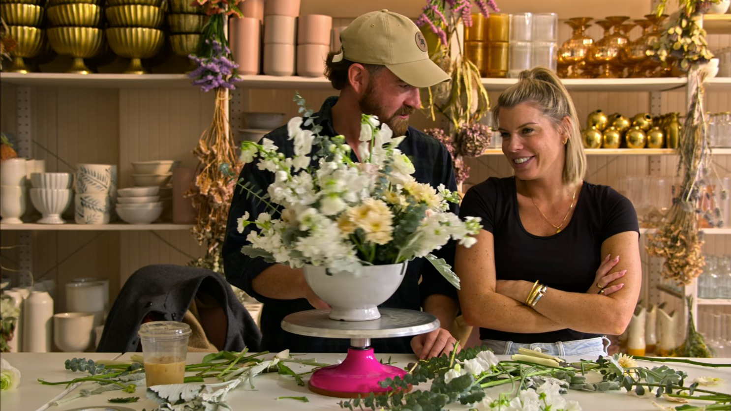 blake and erika and a load of flowers looking slightly happy on love is blind