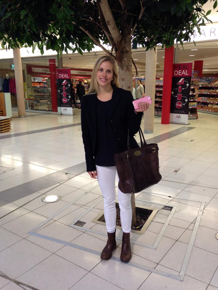 Ellen is pulling a school girl look with her navy blue jacket and adds a twist to it with her skinny white jeans.