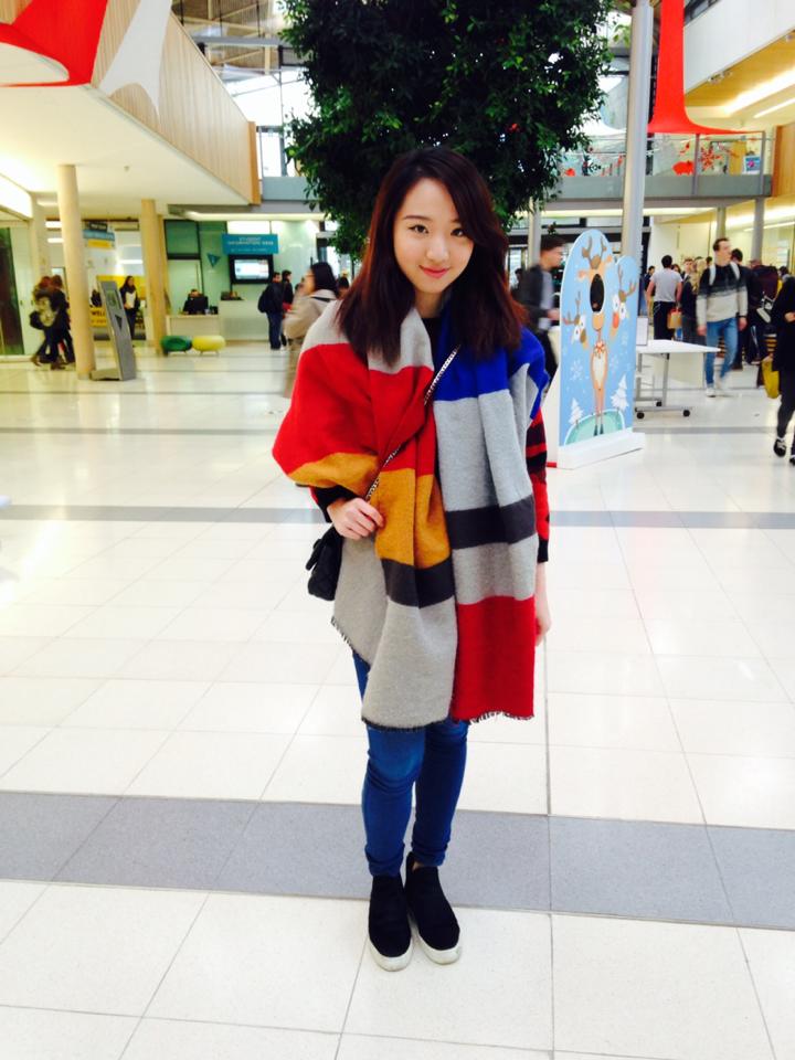Floris is not afraid of popping colors with her warm cozy poncho.