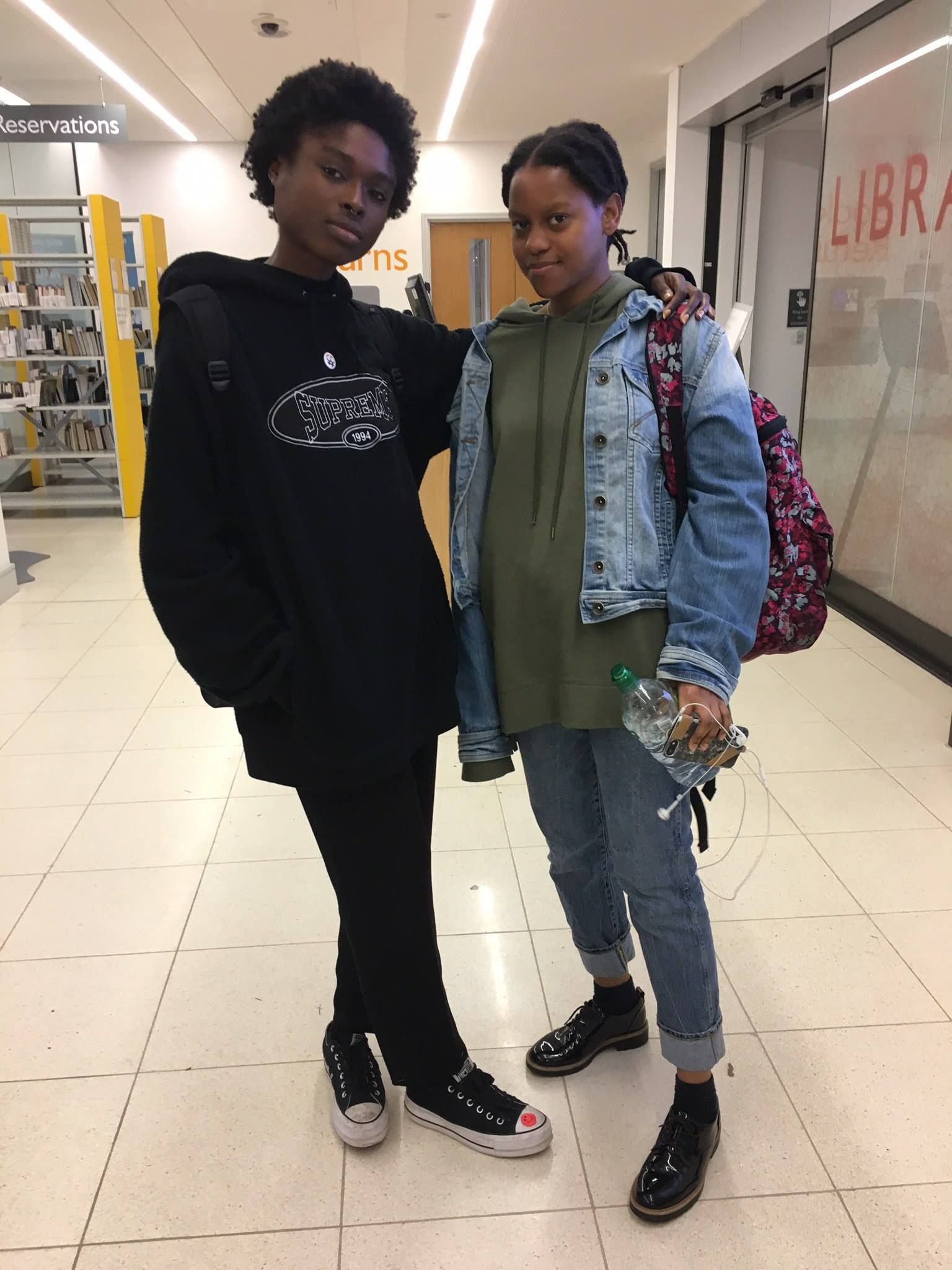 Image may contain: Jacket, Shelf, Afro Hairstyle, Coat, Overcoat, Pants, Hair, Long Sleeve, Footwear, Shoe, Human, Person, Sleeve, Clothing, Apparel
