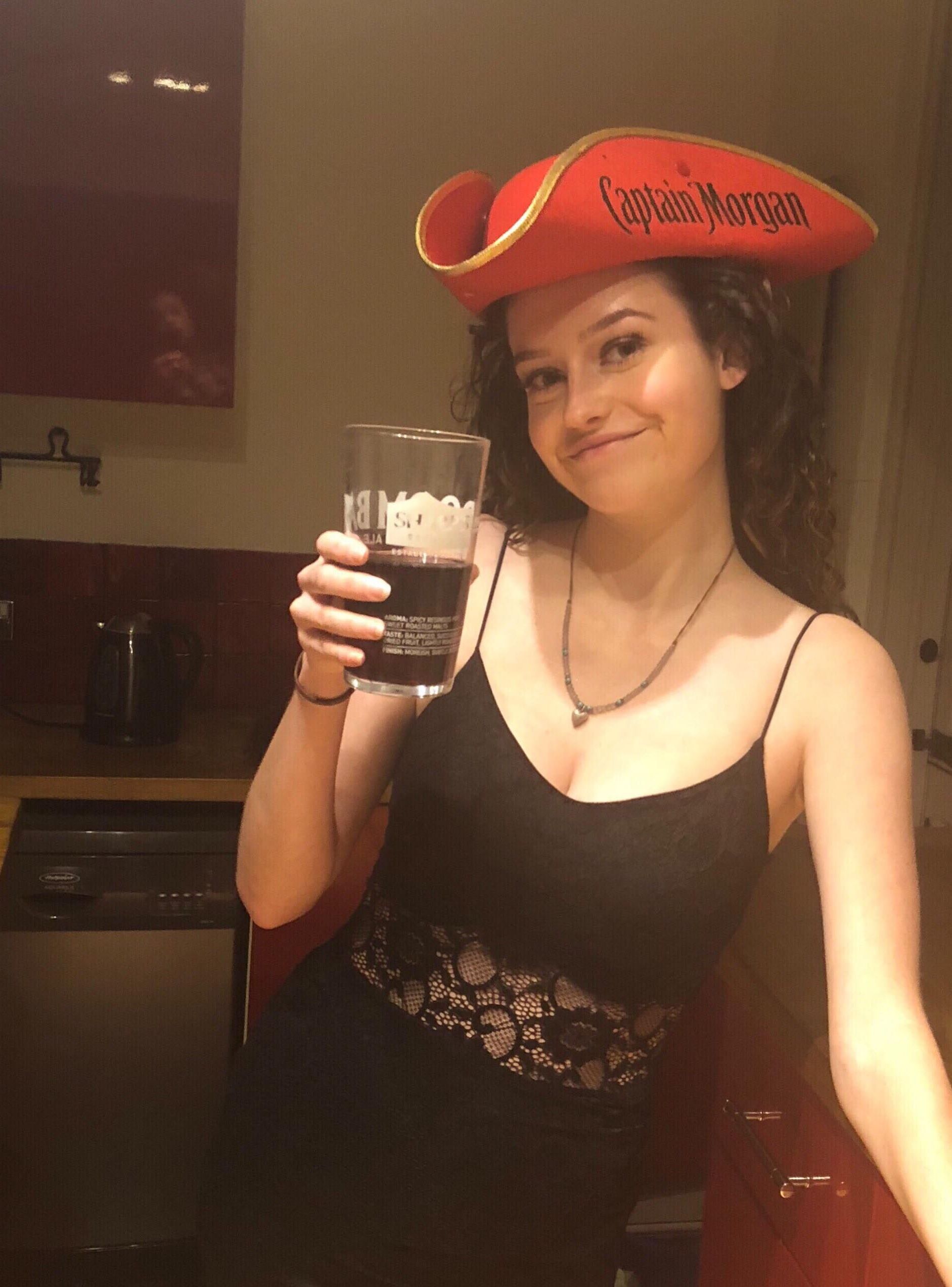 Image may contain: Woman, Drinking, Female, Drink, Beverage, Apparel, Hat, Clothing, Person, Human