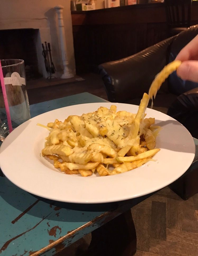 Image may contain: Pasta, Furniture, Table, Dining Table, Person, Human, Food, Fries