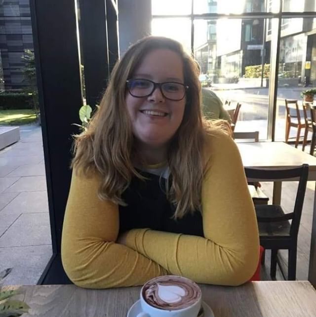 Image may contain: Cup, Coffee Cup, Cafe, Face, Pottery, Chair, Accessory, Accessories, Glasses, Dining Table, Restaurant, Table, Furniture, Human, Person