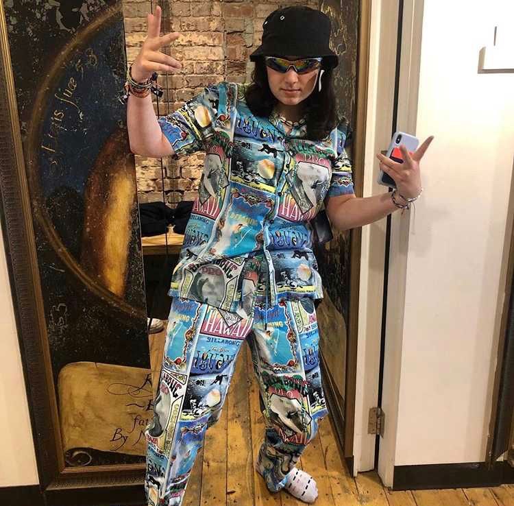 Image may contain: Flooring, Hardwood, Pants, Sleeve, Accessory, Accessories, Sunglasses, Wood, Pajamas, Person, Human, Clothing, Apparel