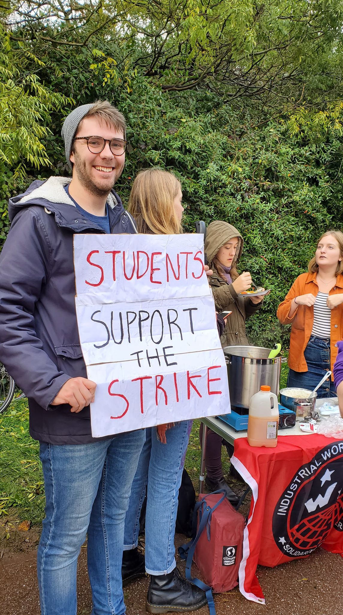 Image may contain: Crowd, Word, Banner, Text, Human, Person