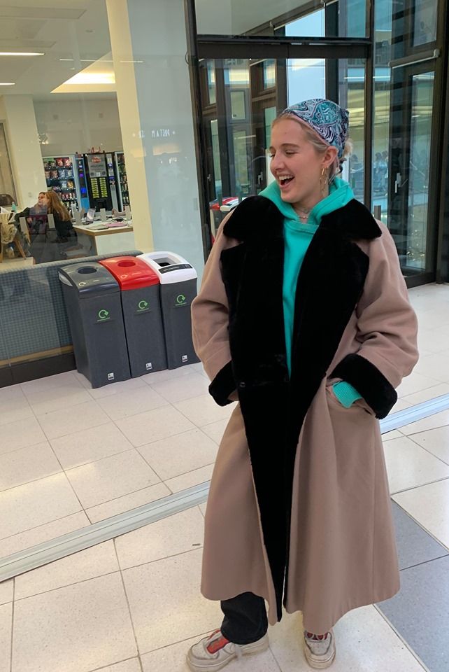 Image may contain: Female, Cape, Sleeve, Costume, Overcoat, Coat, Human, Person, Apparel, Clothing