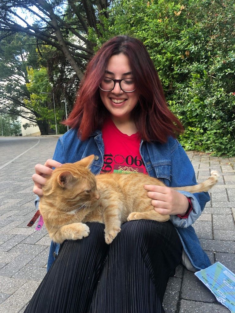 Image may contain: Girl, Tree, Plant, Outdoors, Female, Glasses, Accessories, Accessory, Denim, Jeans, Animal, Mammal, Pet, Cat, Pants, Apparel, Clothing, Human, Person