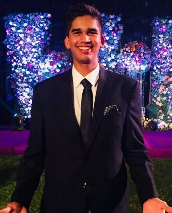 Image may contain: Lighting, Man, Face, Tie, Accessory, Accessories, Tuxedo, Person, Human, Plant, Tree, Jacket, Blazer, Clothing, Apparel, Coat, Overcoat, Suit