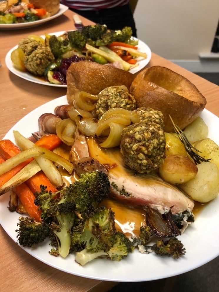 Image may contain: Human, Person, Dining Table, Furniture, Table, Platter, Bread, Dish, Meal, Vegetable, Plant, Broccoli, Supper, Dinner, Food