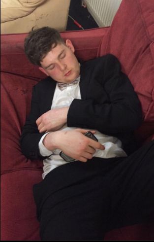 Image may contain: Asleep, Suit, Overcoat, Coat, Clothing, Person, People, Human