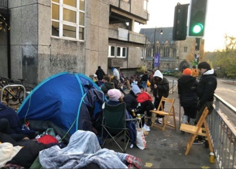 Image may contain: Camping, Urban, Crowd, Traffic Light, Light, Tent, Human, Person