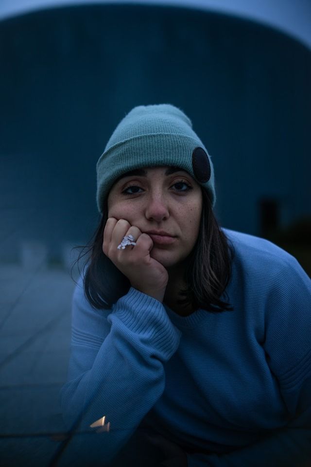 Image may contain: Beanie, Hat, Cap, Finger, Person, Human, Apparel, Clothing