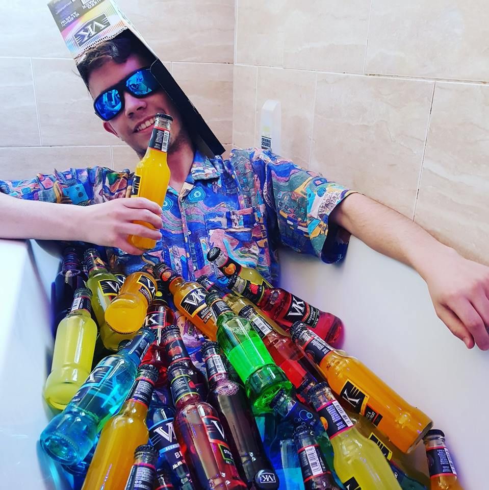 Image may contain: Bottle, Drink, Beverage, Person, Performer, Human, Clown