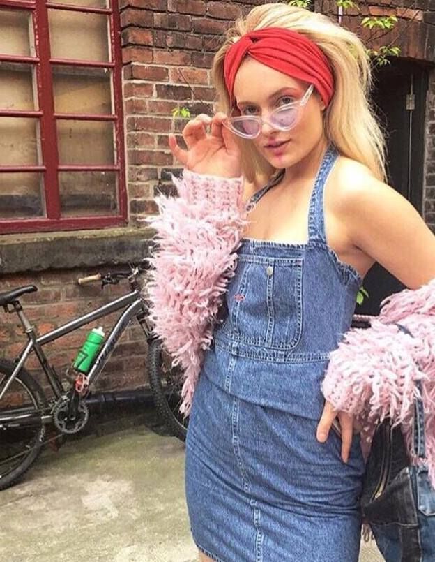 Image may contain: Pants, Jeans, Denim, Clothing, Woman, Girl, Female, Blonde, Vase, Pottery, Potted Plant, Plant, Jar, Flora, Vehicle, Transportation, Bike, Bicycle, Person, People, Human