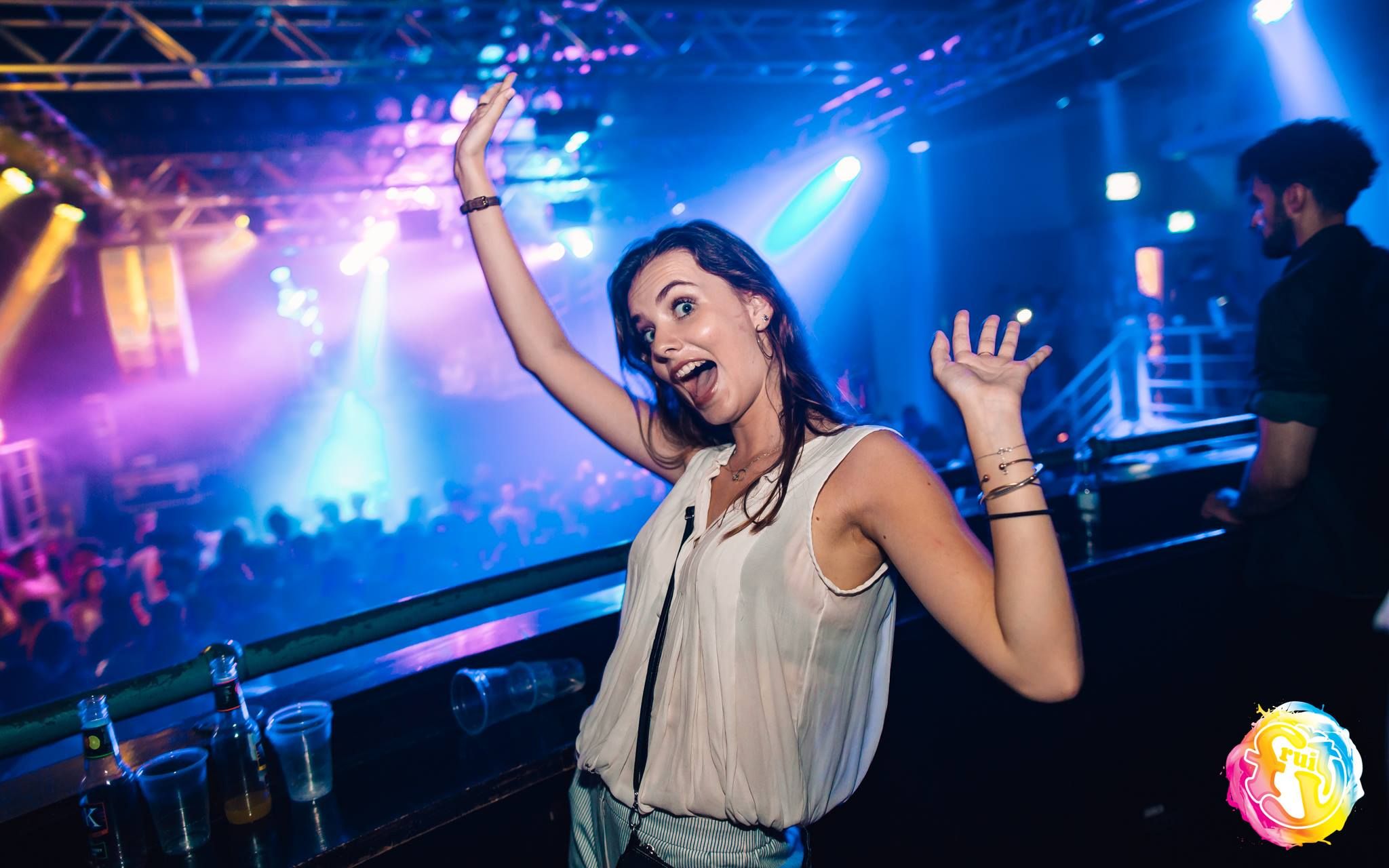 Image may contain: Sweets, Lollipop, Food, Confectionery, Candy, Night Life, Night Club, Club, Neon, Light, Person, People, Human
