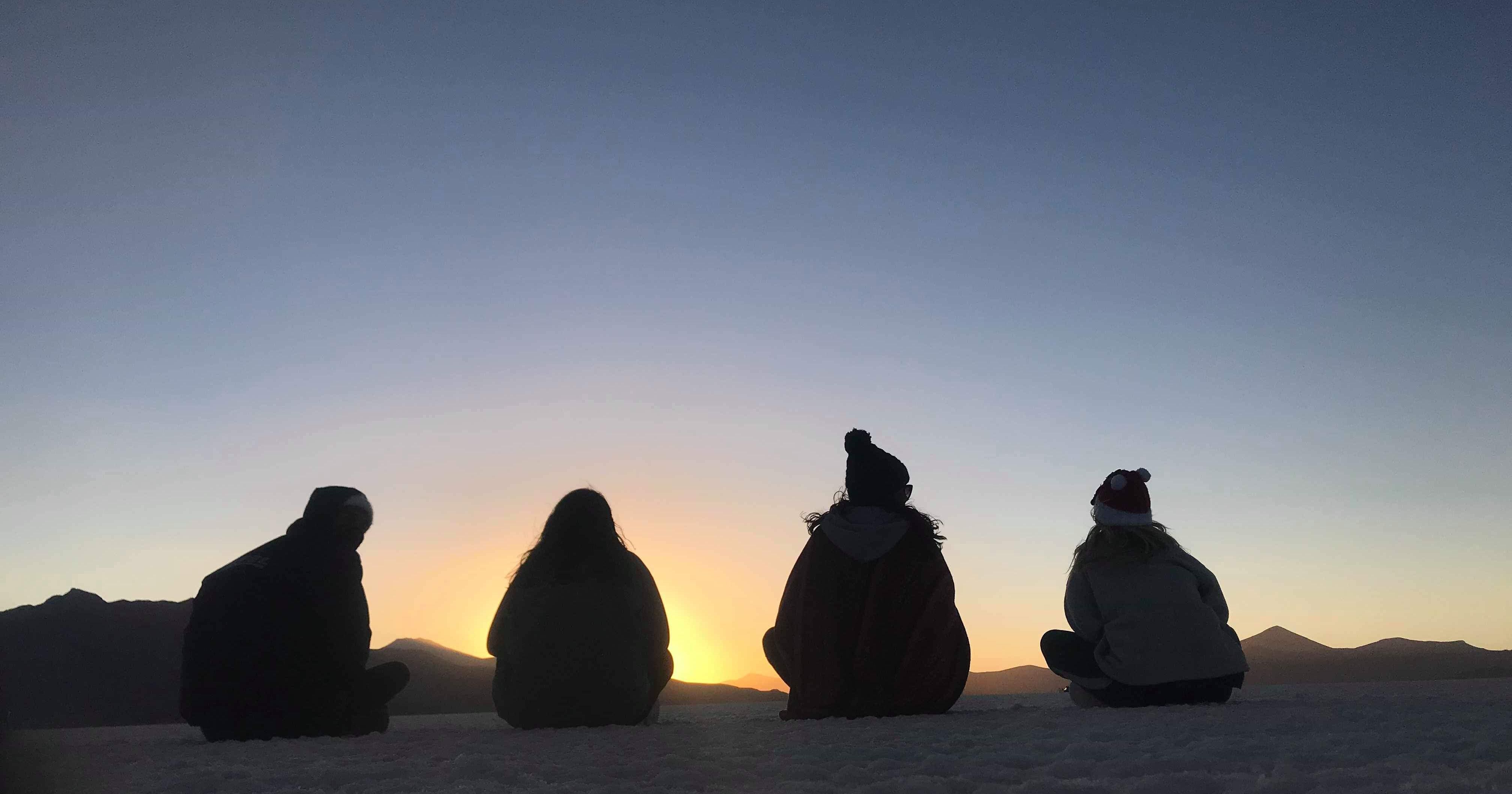 Image may contain: Sky, Dawn, Sunset, Red Sky, Dusk, Adventure, Leisure Activities, Worship, Animal, Bird, Penguin, Human, Person, Outdoors, Silhouette, Nature, Architecture, Dome, Building