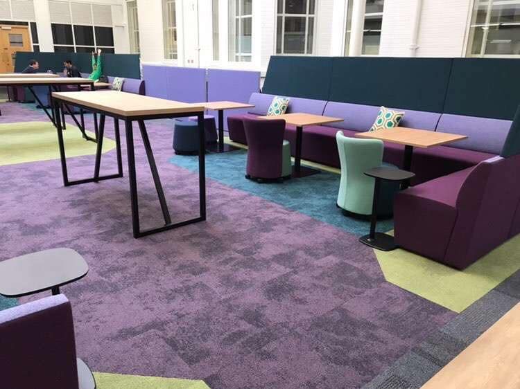 Image may contain: Chair, Rug, Person, Human, Table, Furniture