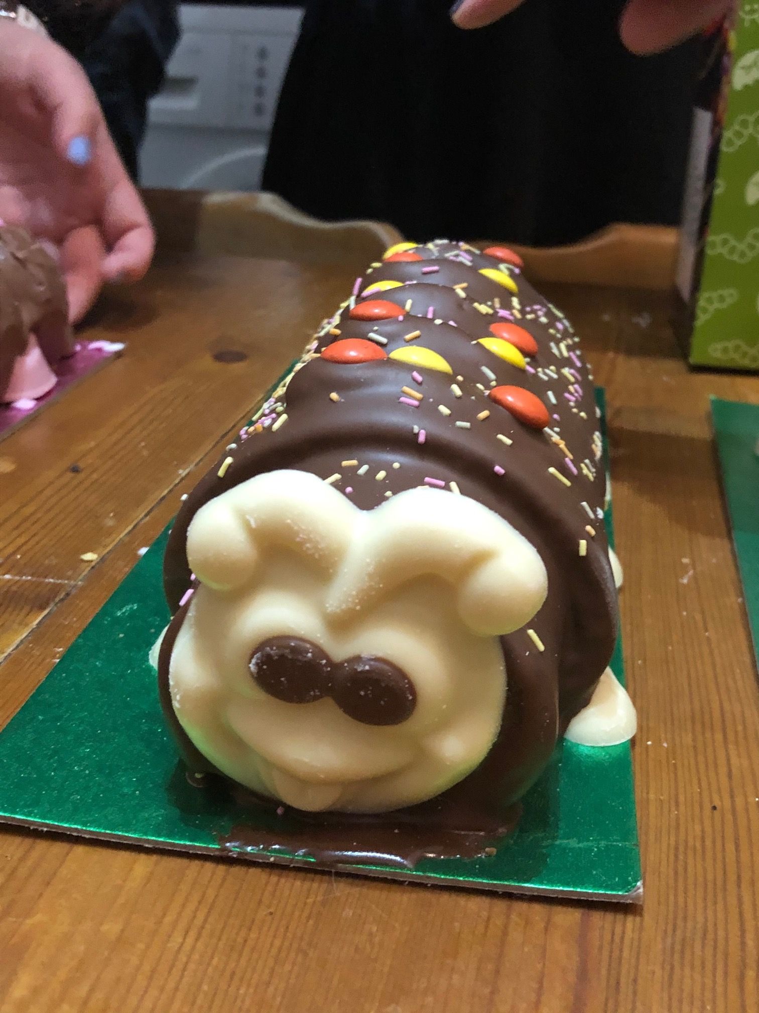 Image may contain: Finger, Hardwood, Wood, Egg, Dessert, Icing, Creme, Cake, Cream, Sweets, Food, Confectionery, Human, Person