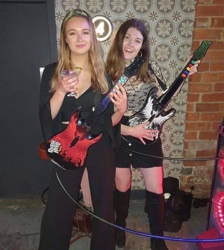 Image may contain: Dress, Musician, Female, Costume, Interior Design, Indoors, Guitar, Musical Instrument, Clothing, Apparel, Leisure Activities, Person, Human