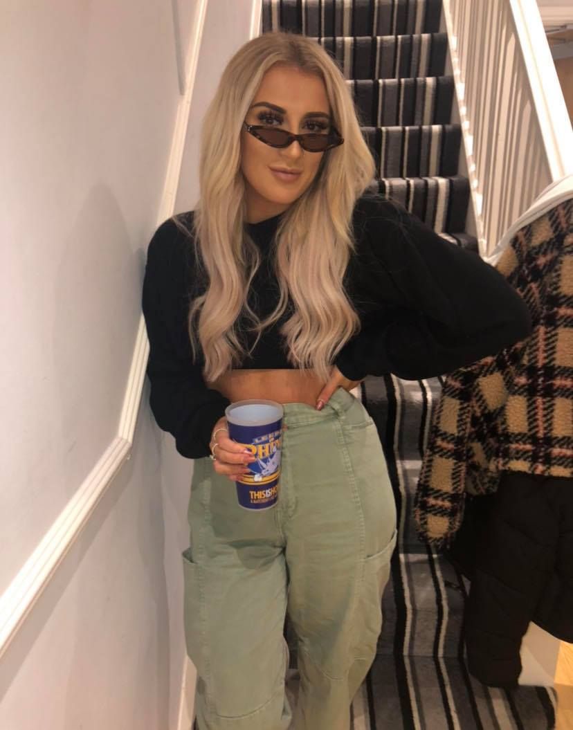 Image may contain: Tin, Accessories, Accessory, Sunglasses, Female, Sleeve, Pants, Shorts, Human, Person, Clothing, Apparel