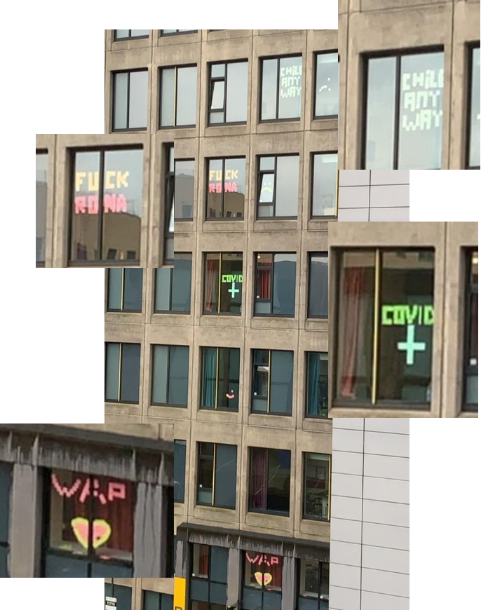 A photo of several windows in Central Village displaying post-it note messages