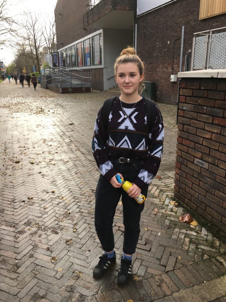 Big jumpers are just what every student lives for, but being able to style them well is an art. Here Tiggy Rose very nicely sports a fashionable patterned jumper with a pair of black 'mom' jeans and a cool AND efficient up-do bun.