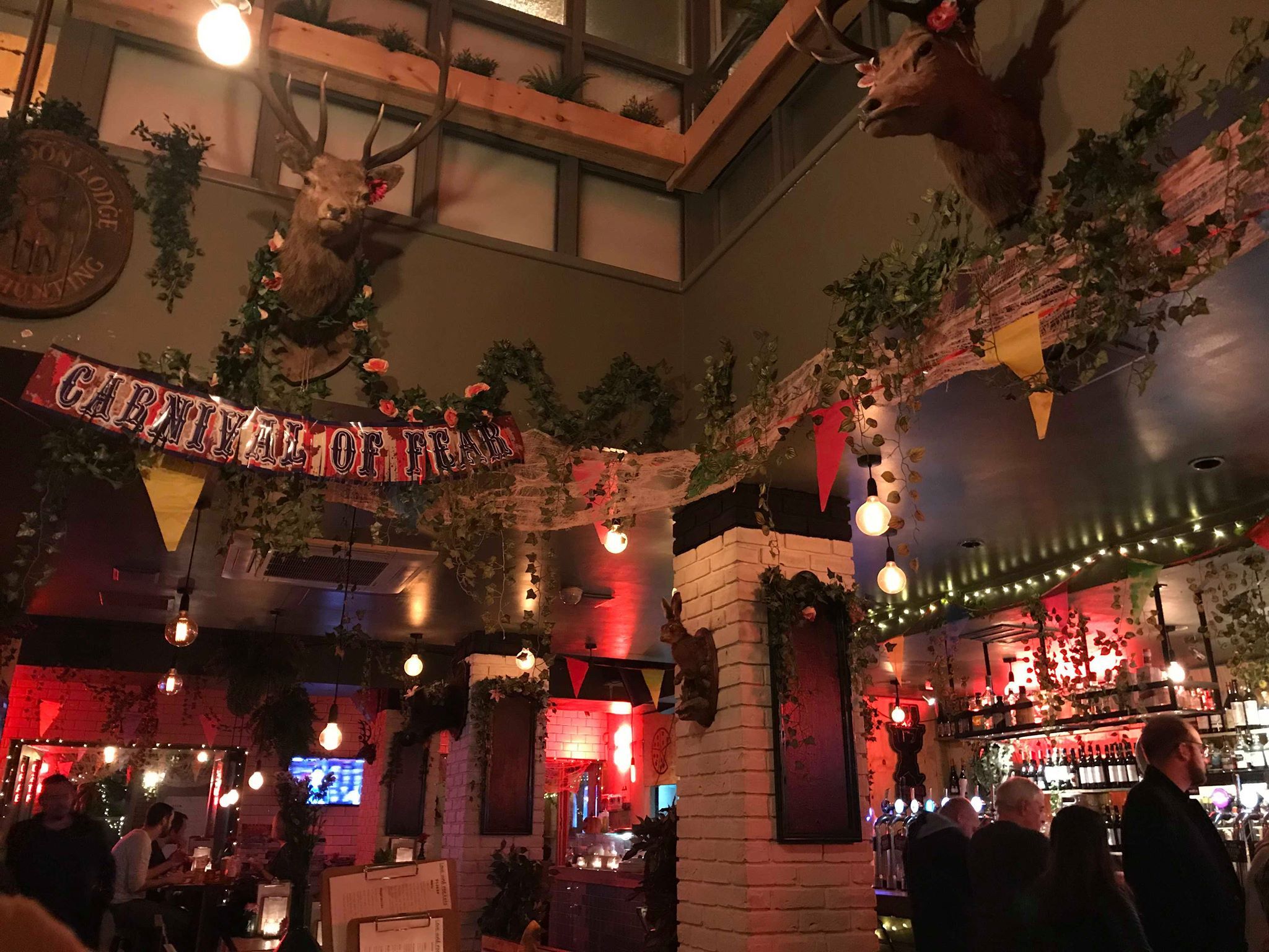 Image may contain: Lighting, Pub, Bar Counter, Person, People, Human, Vase, Pottery, Potted Plant, Plant, Jar, Flora