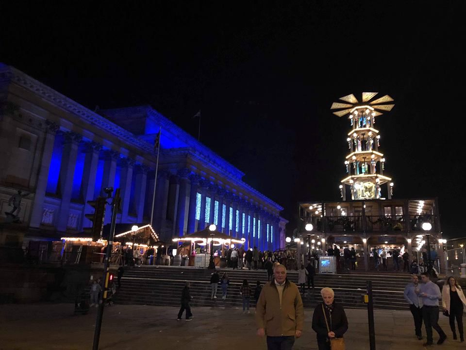 Image may contain: Apparel, Clothing, Lighting, Town Square, Plaza, Metropolis, Architecture, Pedestrian, Person, Human, City, Building, Town, Urban, Downtown