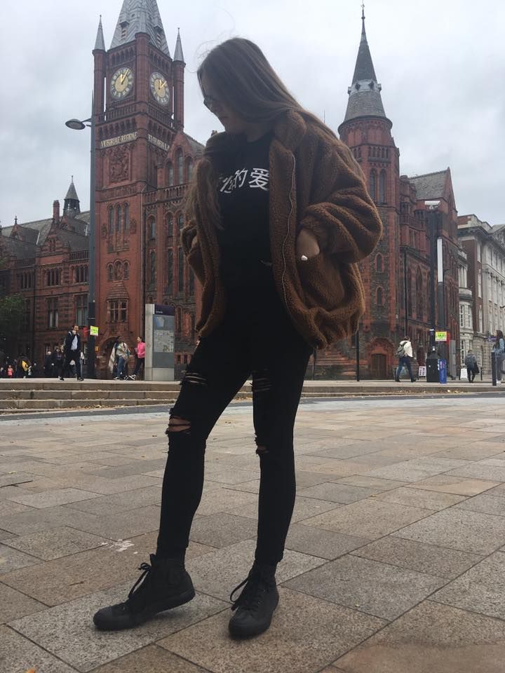 Image may contain: Coat, Spire, Steeple, Downtown, Metropolis, Urban, Town, City, Clock Tower, Shoe, Footwear, Human, Person, Clothing, Apparel, Architecture, Building, Tower