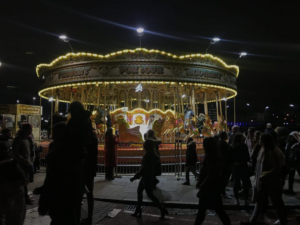 Image may contain: Pedestrian, Carousel, Theme Park, Amusement Park, Human, Person