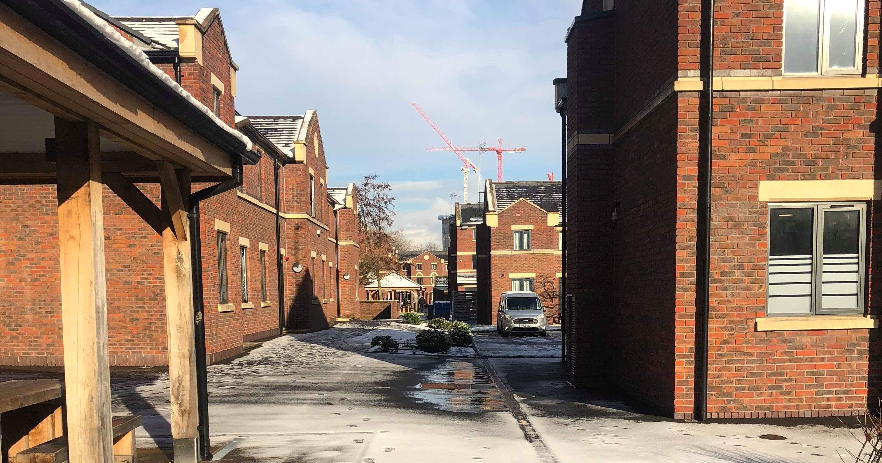 Image may contain: Roof, Construction Crane, Walkway, Brick, Asphalt, Tarmac, Path, Alleyway, Alley, Neighborhood, Road, City, Street, Building, Town, Urban