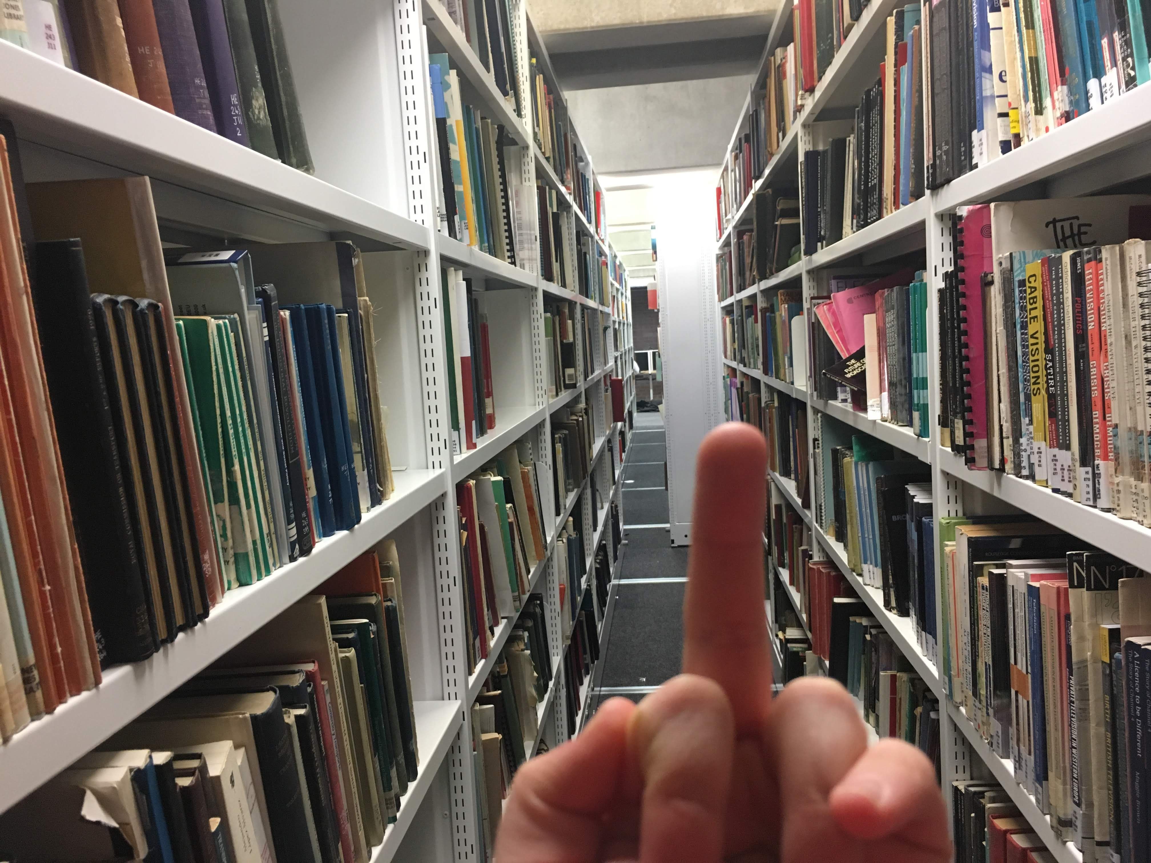 Image may contain: Aisle, Human, Person, Bookcase, Library, Book, Room, Shelf, Furniture, Indoors