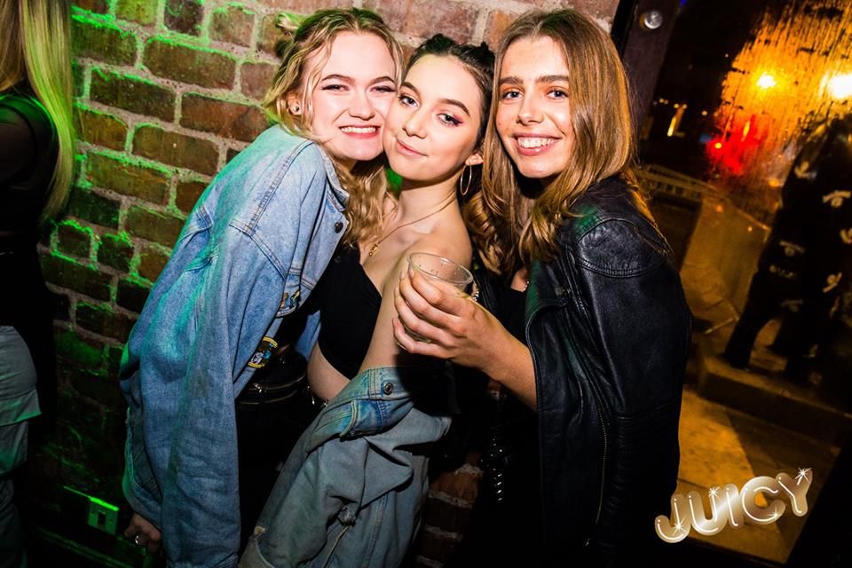Image may contain: Face, Party, Night Club, Brick, Jacket, Coat, Club, Clothing, Apparel, Human, Person