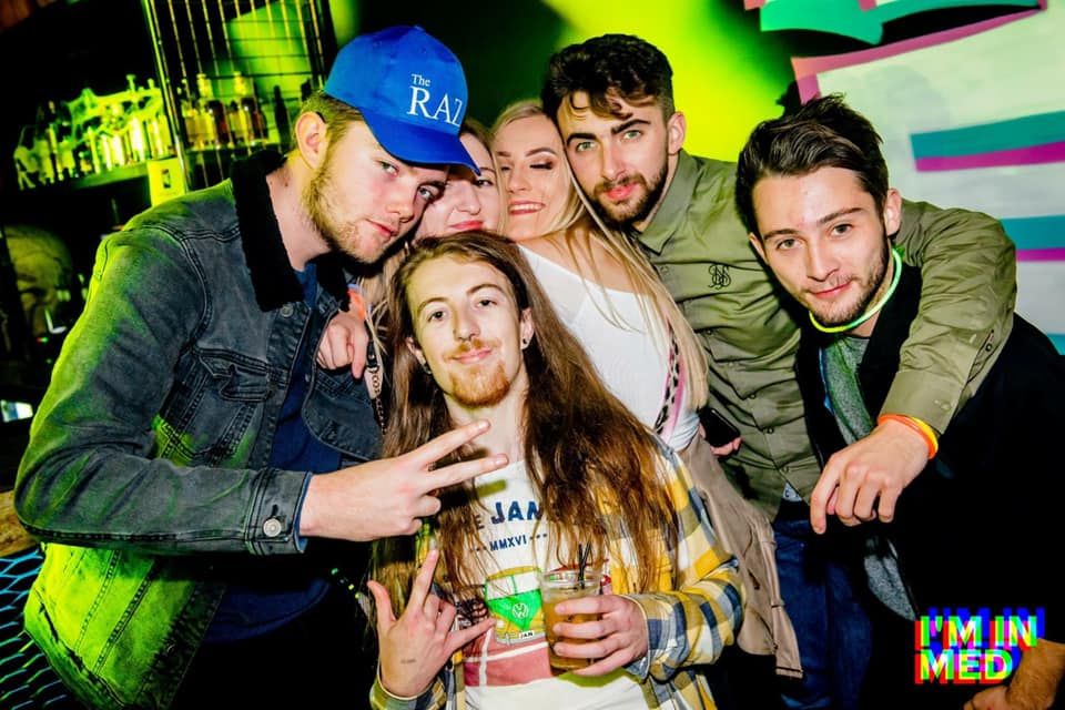 Image may contain: People, Apparel, Clothing, Hat, Pub, Night Club, Club, Party, Person, Human