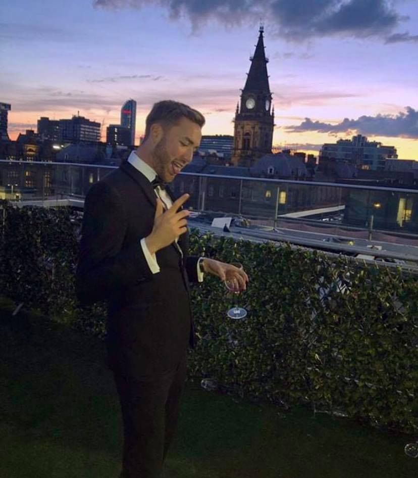 Image may contain: Mansion, House, Outdoors, Housing, Blazer, Jacket, Downtown, Clock Tower, Overcoat, Suit, Coat, Person, Human, High Rise, Apparel, Clothing, Architecture, Tower, Spire, Steeple, City, Metropolis, Building, Urban, Town