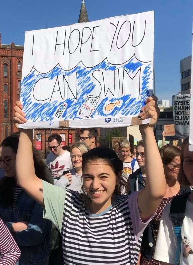 Image may contain: Face, Parade, Crowd, Banner, Text, Person, Human