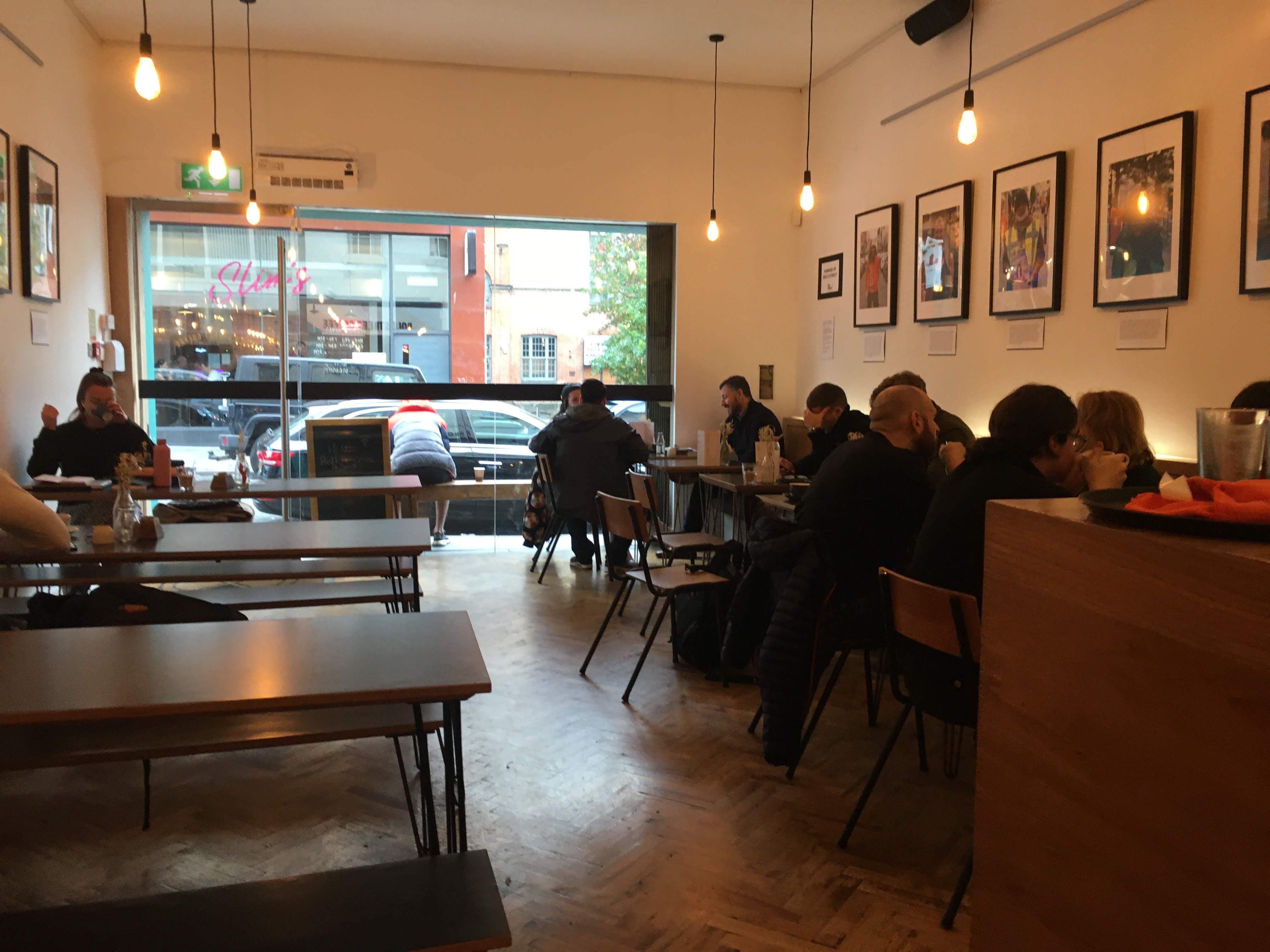 Image may contain: Floor, Furniture, Chair, Wood, Flooring, Cafeteria, Person, Human, Cafe, Restaurant