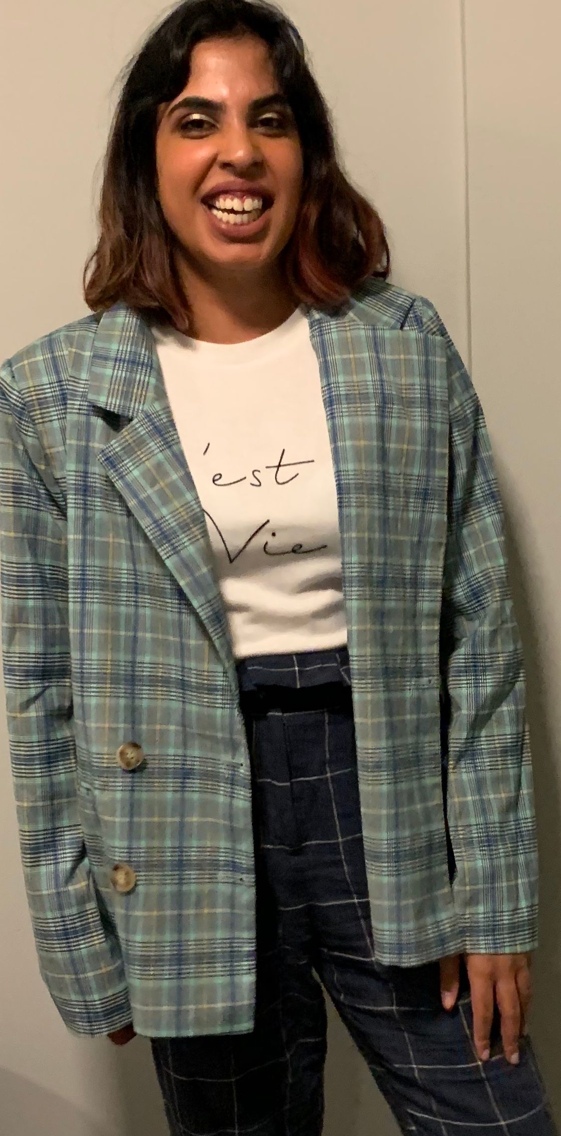 Image may contain: Text, Linen, Plaid, Tartan, Long Sleeve, Coat, Overcoat, Person, Human, Sleeve, Home Decor, Clothing, Apparel